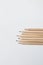 Some of the cream colored wooden pencils have sharp ends.