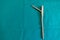Some explanted femoral nail lie spread out on a green surgical drape