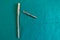 Some explanted femoral nail lie spread out on a green surgical drape