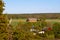 Some farm buildings scattered in the overall flat Scanian landscape in southern Sweden