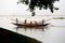 Some fishermen are catching fish with long fishnet from traditional fish-boat in the Meghna river at