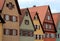 Some houses of varying colors and windows with white windows in the town of Dinkelsbuhl in Germany