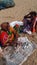 Some Indian fishing seller sitting on sea beach.