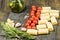 Some ingredients for cooking pasta cannelloni: pasta itself, tomatoes cherry, rosemary, some spices and olive oil on the dark