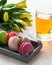 Some macaroons yellow tulips and cup of tea on the wood table spring mothers day