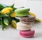 Some macaroons yellow tulips and cup of tea on the wood table spring mothers day morning