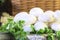 Some natural mushrooms in a basket decorated with parsley leaves.