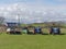 Some old working Tractors with a pair of open wooden Fishing boats parked in a field next to a cottage in Easthaven.