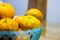 Some oranges in a blue basket