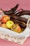 Some overripe fruits in white wicker basket with dirty napkin, tainted bananas, half-peeled and rotten, apples with decay spots on