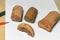 Some peices of clay aged-damaged ceramic artefacts found during the archaeological excavations settled on wooden background with s
