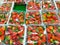 some plastic boxes full of red strawberries wrapped with transparent plastic on a green shelf at the market just harvested and