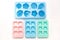 Some plastic ice cube mold trays of different colors