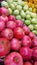 Some pomegranades and artichoques in a street market.