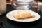 Some prepared ingredients for baking are on the table. Also a plate of sliced butter.