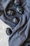 Some ripe plum fruits on dark blue crumpled tablecloth background. Aesthetic still life, flat lay