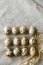 Some rows of quail eggs on linen fablic background