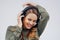 Some songs just make you wanna dance. Studio shot of an attractive young woman dancing against a grey background.