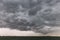 Some spectacular and menacing clouds over a lake, with a distant