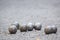 Some steel balls for petanque on crushed stones in a park.