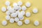 Some tablets white isolated on a yellow background