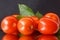 some tomatoes with green leaves in the mirror