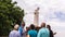 Some tourist infront of the armless marble statue of St. Francis Xavier at the ruins of St. Pauls Church