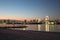 Some tourist standing at port and seeing light illumination decoration from rainbow bridge with blue and orange sky at evening