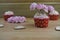 Some Valentines day romantic cup cakes with pink paper roses for decoration on top
