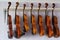 Some violins hanging in a luthier workshop