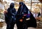 Some women with veil and burqain the souk of the city of Rissani in Morocco