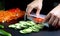 Someone slicing cucumbers on a cutting board