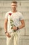 For someone special. Man with rose. Handsome man holding red rose. Attractive man with flower. Sexy man preparing