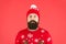 Someone stole christmas. upset because santa delay. has no present. serious hipster red background. bearded man knitted