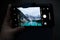 Someone taking a photo of Moraine lake at night using a smartphone.   Banff National Park