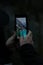 Someone taking a photo of Moraine lake at night using a smartphone.   Banff National Park