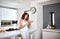 Somethings arent meant to be bottled up. Shot of young woman standing in the kitchen indulging on a sweet delight.