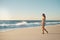 Sometimes the beach is all you need. Shot of a young woman taking a stroll on the beach.