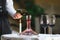 A sommelier pouring red wine into decanter