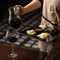 Sommelier pours red wine from glass jug into wine glass while offering tray with cheese snack for it