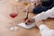 Sommeliers making notes during wine tasting at table indoors, closeup