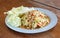 SomTam, Green papaya salad Thai cuisine spicy delicious on wooden plate with copy space