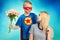 The son in the costume of a superhero gives his mother a bouquet of flowers.