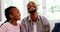 Son and daughter kissing father in living room