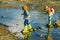Son and daughter playing in the river. Children playing on mountain stream. Kids enjoying a lovely summer day.