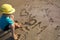 Son draws on the sand, confesses love to his beloved mother on the beach