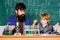 Son and father at school. small boy with teacher man. training room with blackboard. Flask in scientist hand with Test