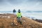 Son and father walk with dog on hill with top view panorame on c