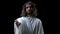 Son of God in crown of thorns stretching out hand on dark background, mercy