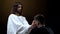 Son of God supporting crying desperate man on dark background, spiritual help